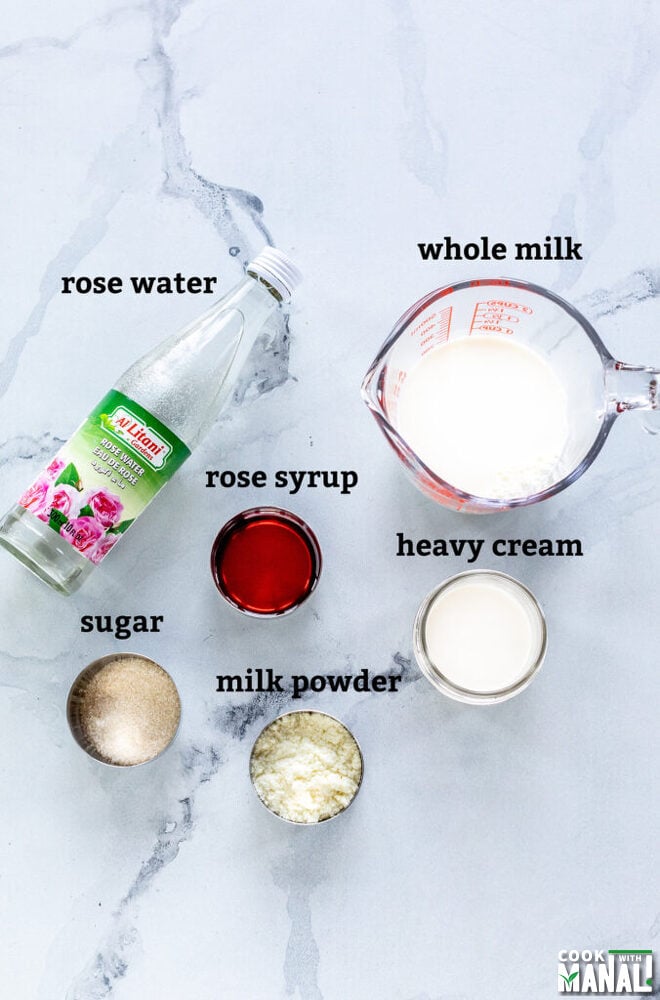 measuring jar filled with milk, bowls with sugar, milk powder, rose syrup arranged on a board