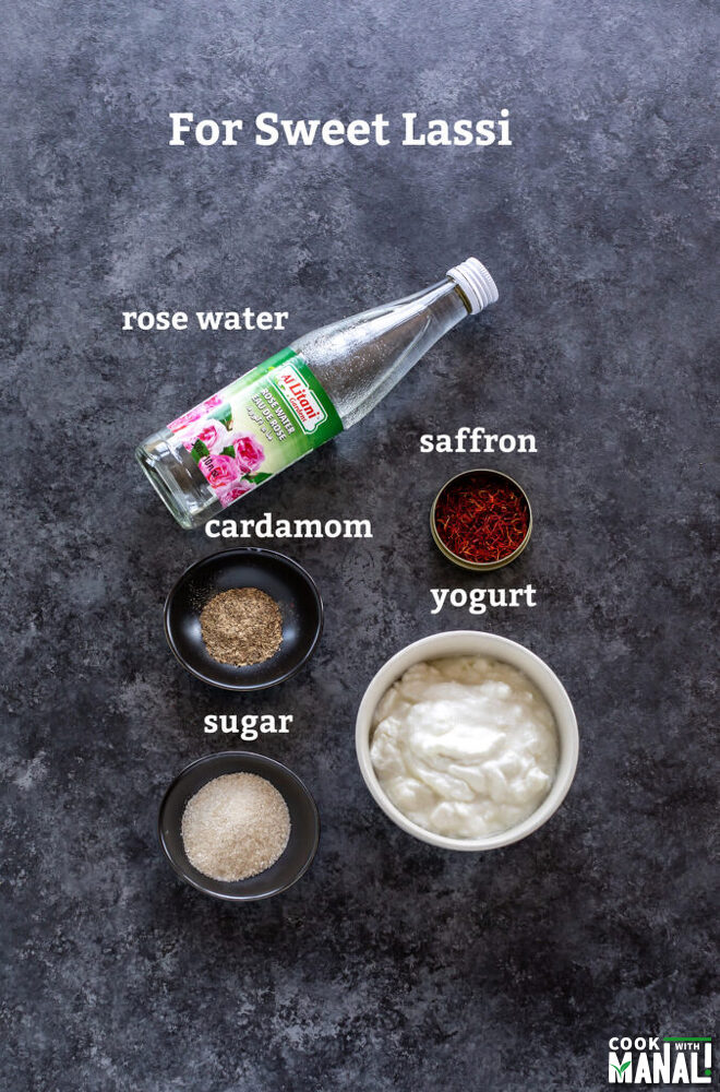 bowls with sugar, yogurt, cardamom powder and saffron with bottle of rose water on the side