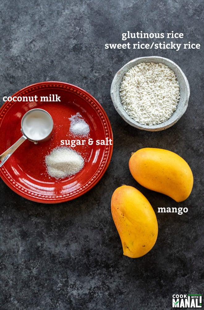 bowl of raw rice, 2 mangoes and a plate with some sugar, salt and coconut milk arranged on a plate