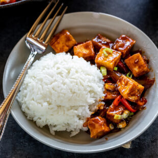 tofu served with white rice in a bowl