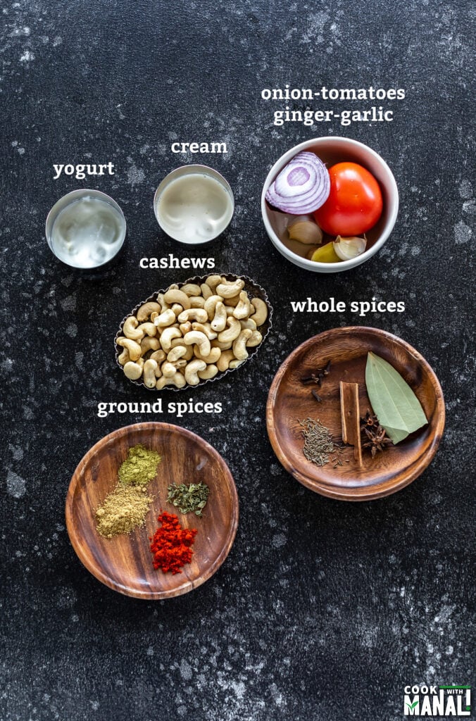 ingredients for making cashew curry arranged on a board