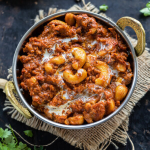 cashews with spices served in a copper kadai