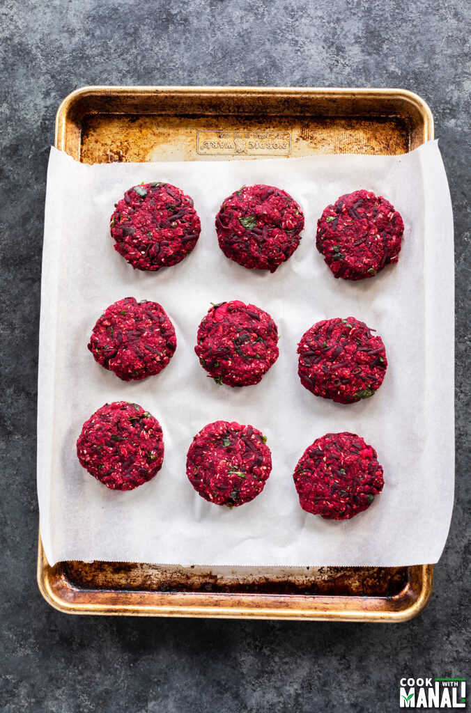 shaped beetroot tikkis arranged on a baking tray