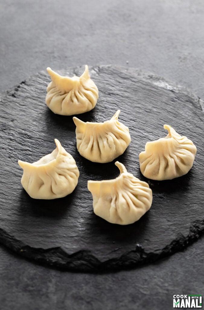 shaped momos arranged on a black board