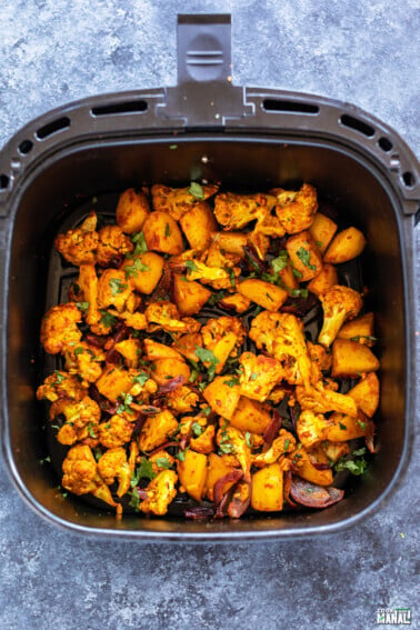 aloo gobi placed in air fryer basket