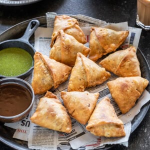 samosa arranged on a plate lined with newspaper