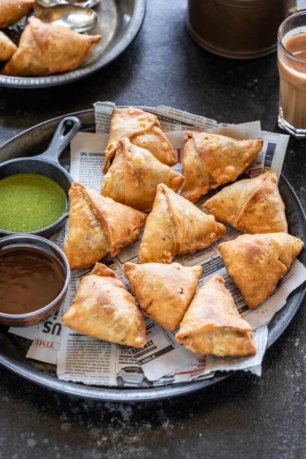 samosa arranged on a plate lined with newspaper
