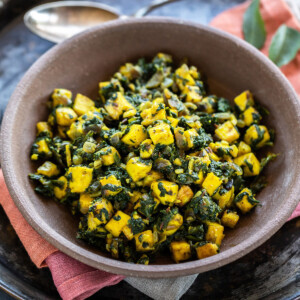paneer and spinach stir fry served in a brown color bowl