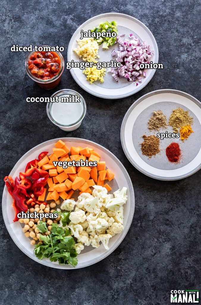 ingredients for vegetable chickpea coconut curry arranged on a board