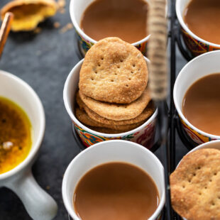mathris arranged with glasses of chai in a glass holder