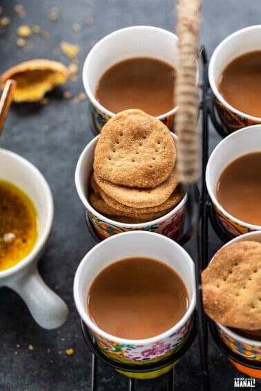 mathris arranged with glasses of chai in a glass holder