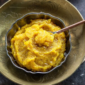 almond halwa served in a bowl garnished with saffron strands