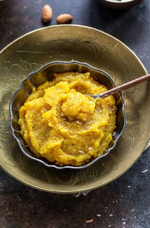 almond halwa served in a bowl garnished with saffron strands