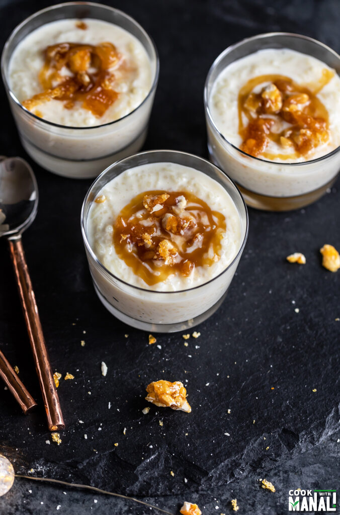 rice pudding served in a bowl topped with caramel sauce