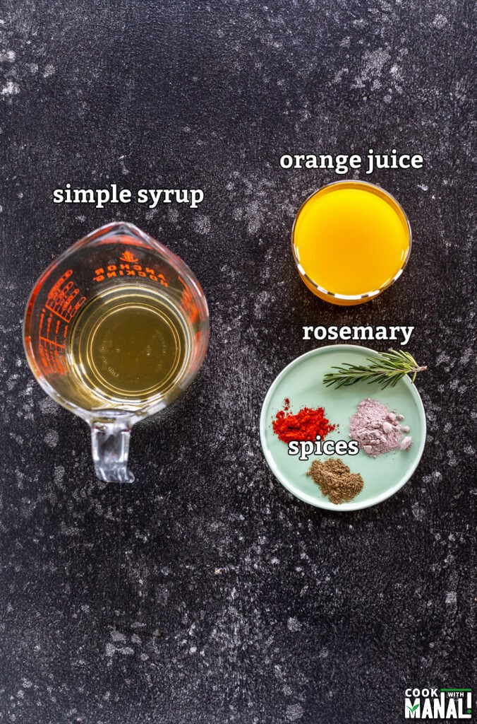 ingredients for orange rosemary mocktail arranged on a board