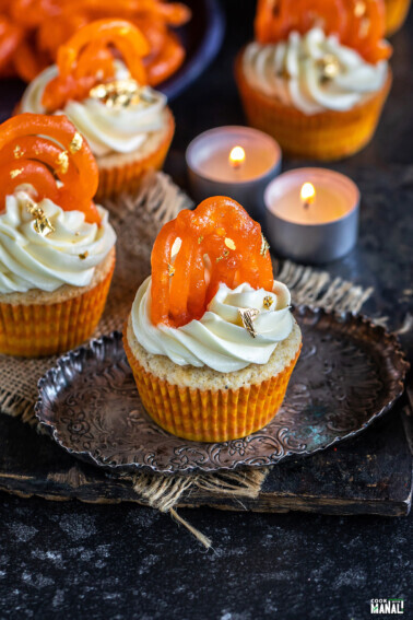 cupcakes topped with jalebi and tealights placed in the background