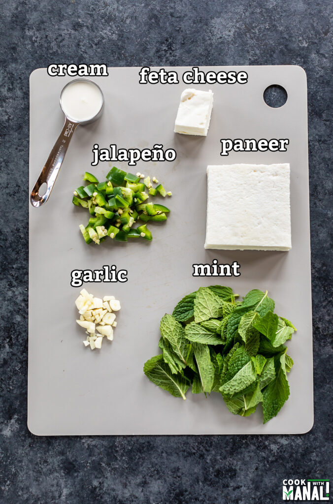 ingredients for making paneer dip arranged on a board