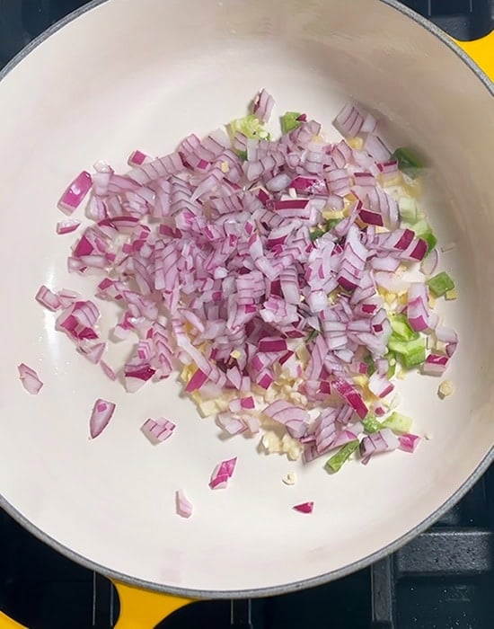 chopped onion, ginger, garlic in a dutch oven pot
