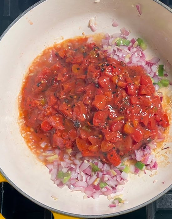 can of crushed tomatoes added to a pot