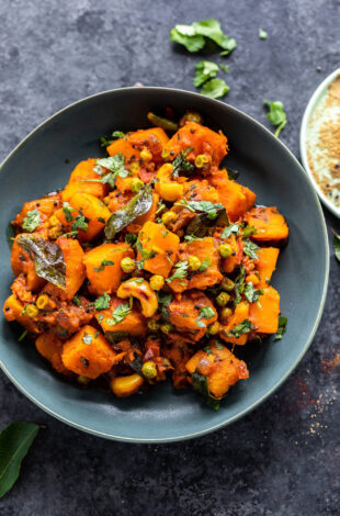 butternut squash cooked with spices and garnished with cilantro served in a bowl