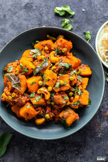 butternut squash cooked with spices and garnished with cilantro served in a bowl