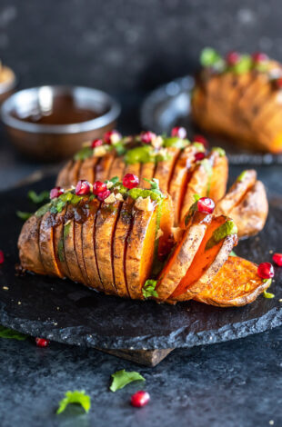 hasselback potatoes sliced into thick slices and drizzled with chutneys and topped with cilantro, mint