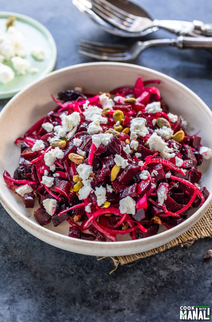 diced beets topped with goat cheese, pistachios served in a white bowl