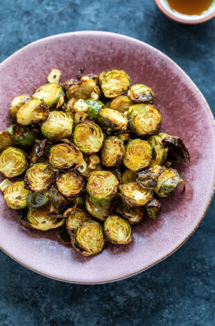 roasted brussel sprouts served in a pink color plate