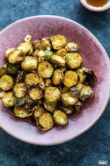 roasted brussel sprouts served in a pink color plate