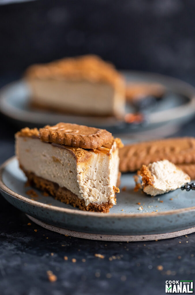 slice of biscoff cheesecake cut to show the texture of the cheesecake