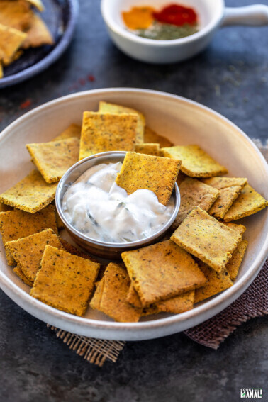 masala crackers dipped in white color sauce