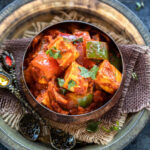 paneer and bell peppers served in a copper bowl