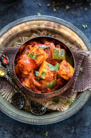 paneer and bell peppers served in a copper bowl