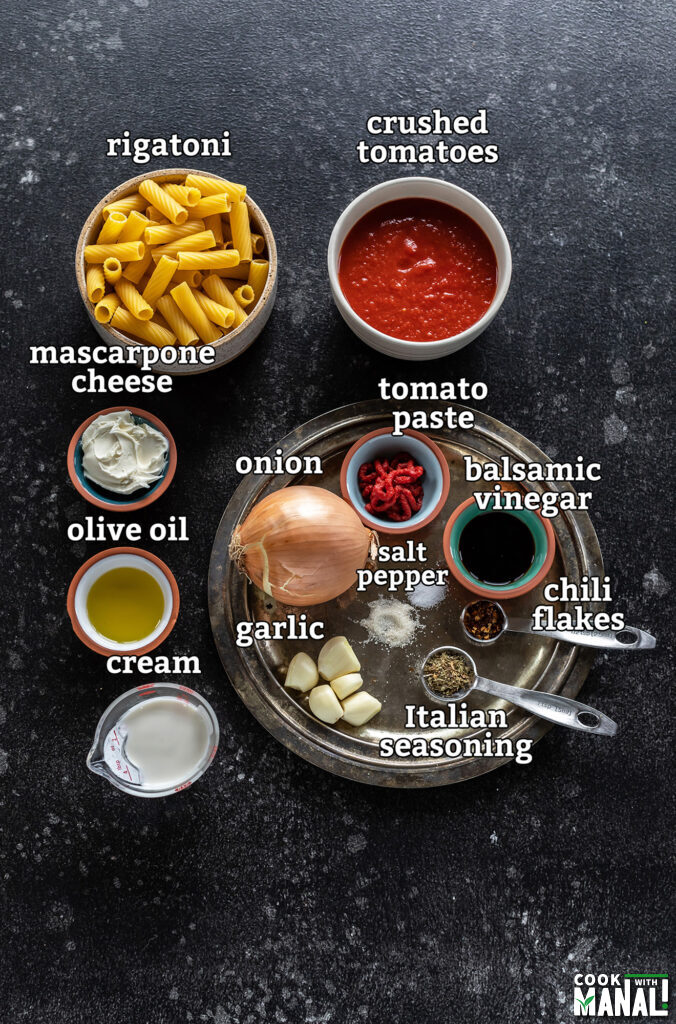 ingredients for instant pot rigatoni pasta arranged on a board