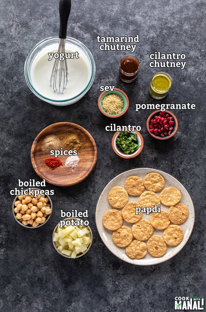 ingredients for making papdi chaat arranged on a board