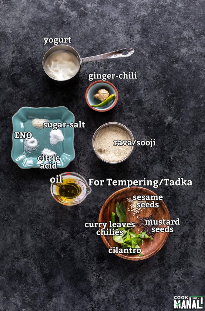 ingredients for making rava dhokla arranged on a board