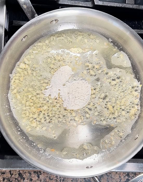 chopped garlic with butter and flour in a steel pan