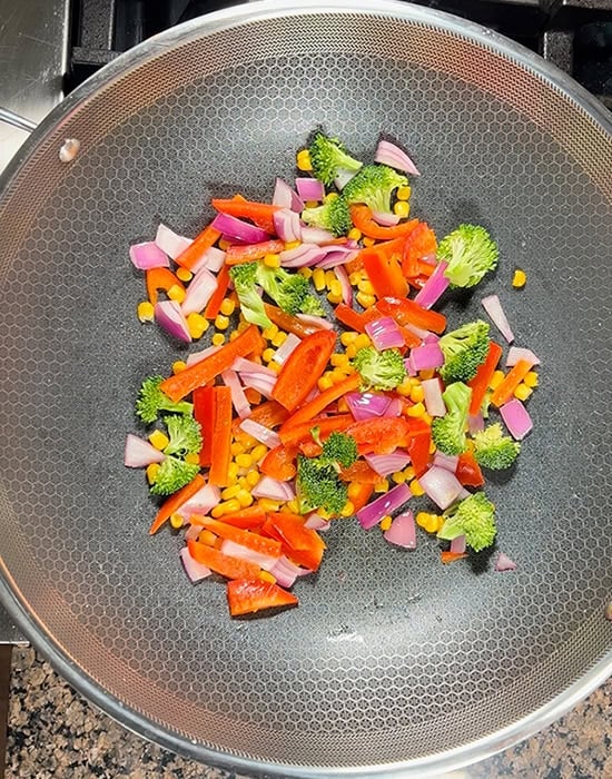 sauteed broccoli, peppers in a pan