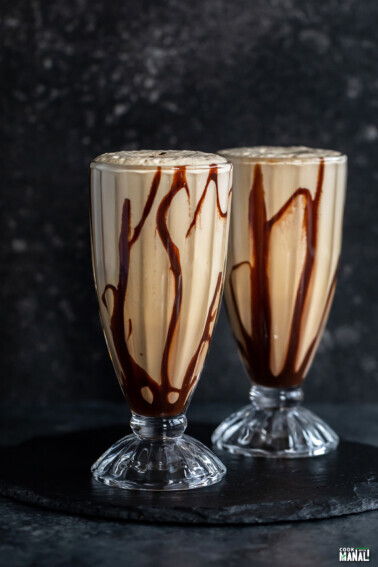 two tall glasses filled with cold coffee