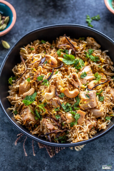 jackfruit biryani served in a black bowl garnished with mint leaves and fried onions