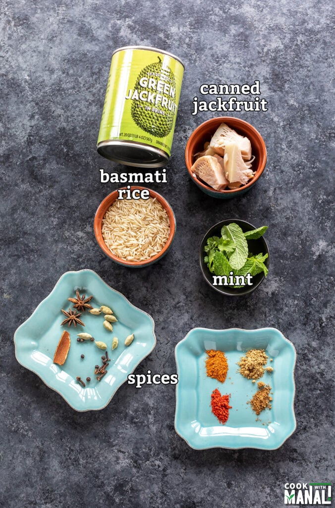 ingredients to make jackfruit biryani arranged on a board