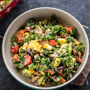bowl of salad with kale, corn, cherry tomatoes