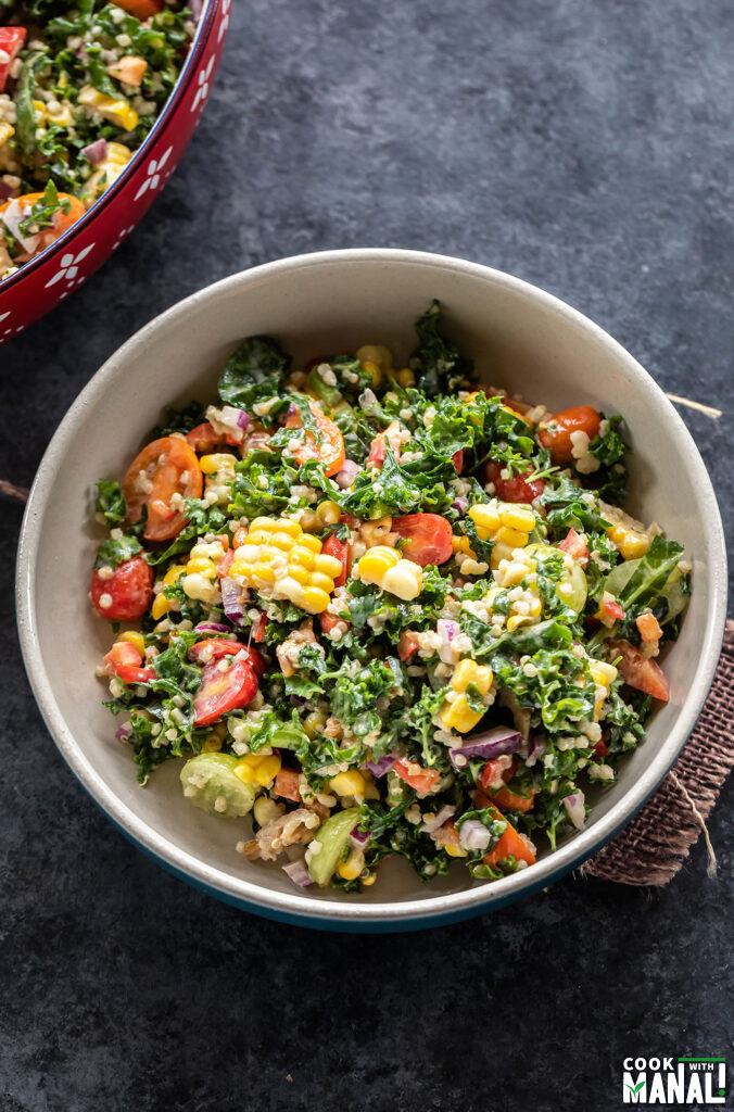 bowl of salad with kale, corn, cherry tomatoes