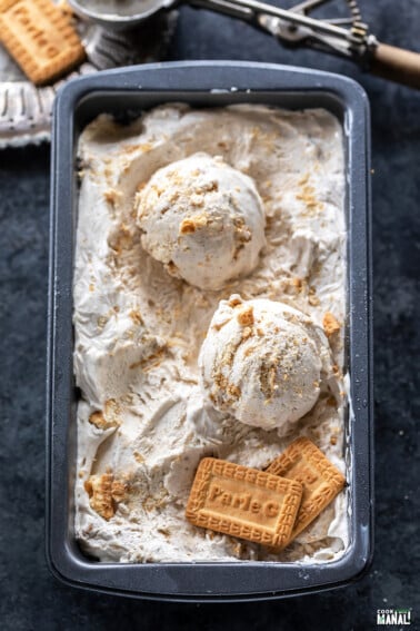 scoops of ice cream in a container with 2 parle-g biscuits placed on one side