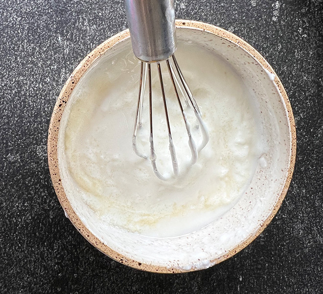 yogurt being whisked in a bowl