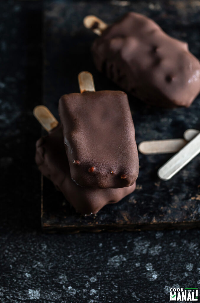 2 choco bar ice creams on top of each other with another choco bar placed on the side