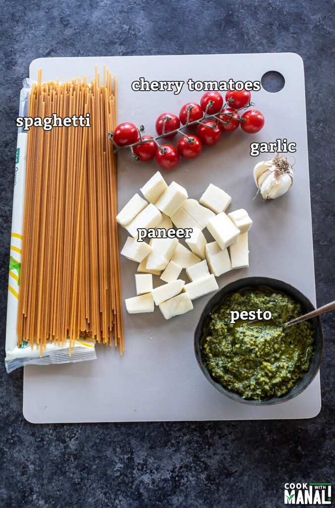 ingredients for paneer pesto pasta arranged on a board