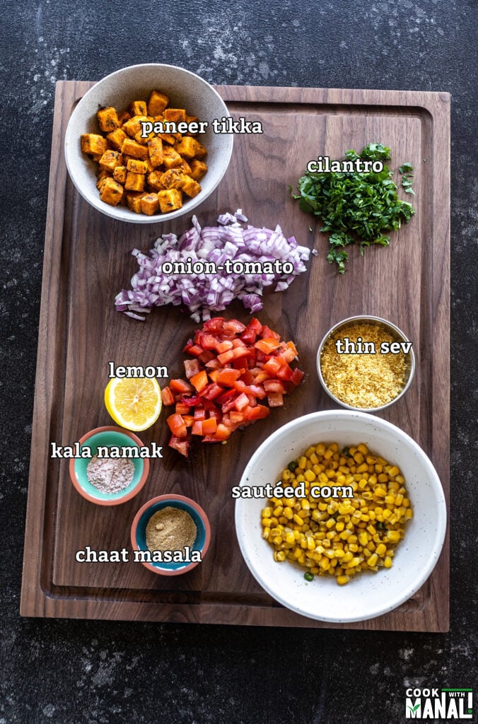 ingredients for paneer tikka corn chaat arranged on a board