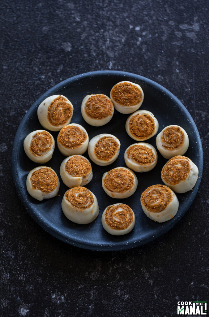 rolled bhakarwadi placed in a plate before frying