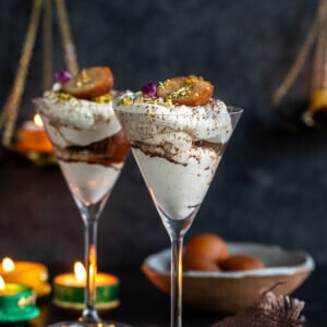 gulab jamun fusion dessert arranged in martini glasses with diyas in the background